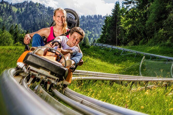 MY<em>GUiDE EXCLUSiVE Neuschwanstein Castle Tour INCL. TiCKETS and ALPiNE COASTER from Munich – Alpine Coaster timing: the adrenaline break that actually fits the day’ /><br />
This tour’s pacing makes room for a physical change of gears. The Alpine Coaster stop is built around chairlift access and a downhill run from about <strong>1,270 meters</strong> altitude to the valley. The track length is listed as <strong>2,600 meters</strong>, so it’s not a quick loop—it’s a real ride.</p>
<p><p>What makes this stop feel dependable is the safety and weather info:</p>
</p>
<ul>
<li>It’s described as <strong>100% safe</strong> (with a safety mechanism that intervenes if someone goes too fast).</li>
<li>The ride is <strong>weatherproof</strong> and can run in rain.</li>
<li>It’s <em>not</em> intended for thunderstorms.</li>
</ul>
<p><p>You control the pace, and the magnetic brakes are a big part of why it works even when conditions aren’t perfect. The coaster tickets cost extra and are <strong>not included</strong> (2025 prices: €17.50 adults, €12.00 children 6–15). Kids rules are also explicit: children can ride only from age 3, and children under 8 can ride only as passengers with an older person (minimum age 16, plus a height requirement).</p>
</p>
<p><p>Here’s the practical takeaway: treat the coaster as a priority. If you’re traveling with kids or teens, this tends to be the “everyone talks about it later” moment because you get both views <em>and</em> motion. Also, bundle your energy wisely—if it’s chilly, wear layers because you’ll be up high where you feel it more.</p>
</p>
<h2 id="oberammergau-murals-wood-carvings-and-a-passion-play-town-feel">Oberammergau: murals, wood carvings, and a Passion Play town feel</h2>
<p><img src=